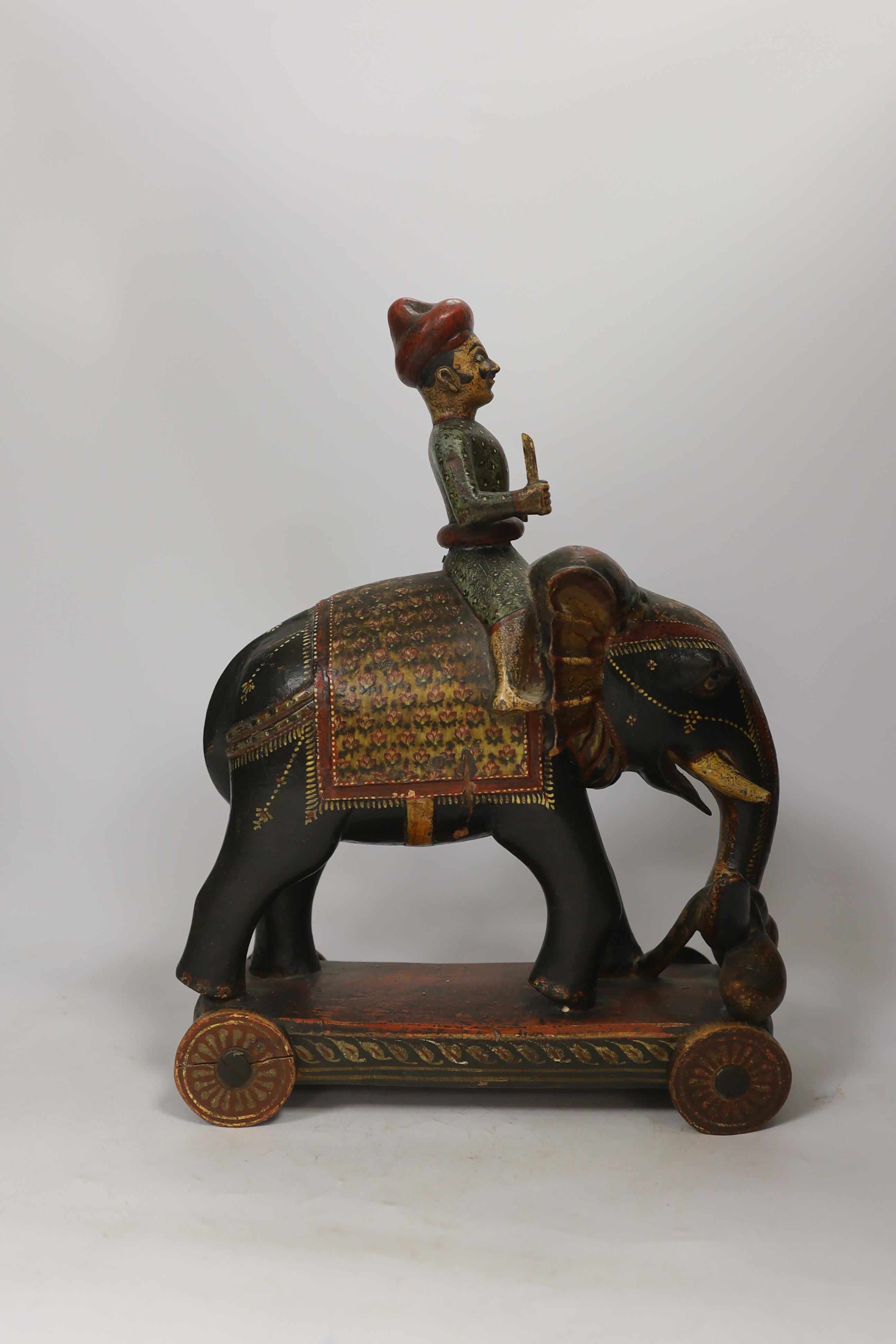 A Rajasthan painted wood elephant and rider pull-along toy, 38cm